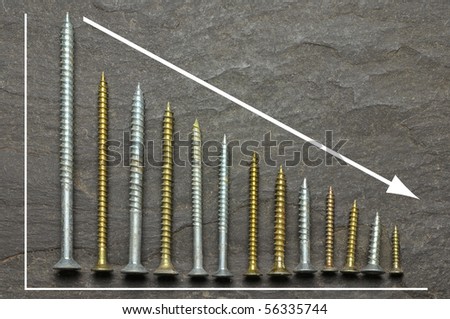 negative graph using various sized screws as bar charts on slate background