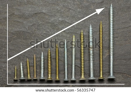 positive graph using various sized screws as bar charts on slate background