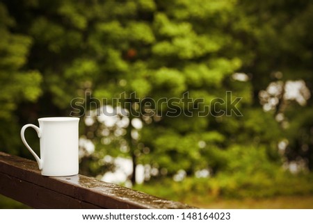 Cup of coffee on a rainy day in nature