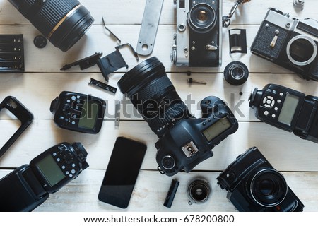 Vintage Film Camera, Digital Camera And Smartphone On White Wooden Background Technology Development Concept. Top View