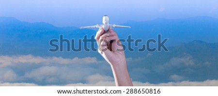 Handle model airplanes. The concept,Travel around the world. background mountains and the sky.