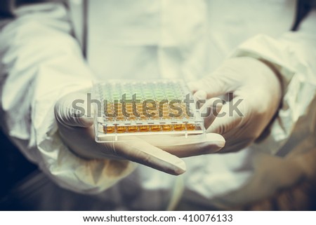 Scientists hold Various cell culture plates  so isolated in the laboratory.