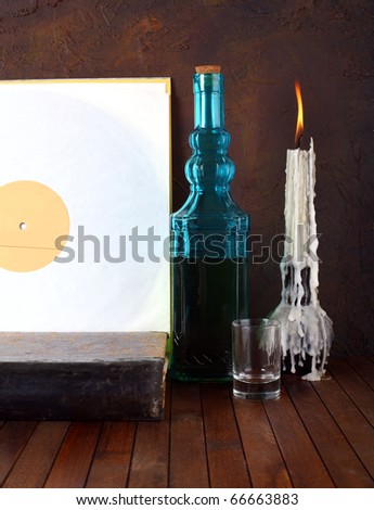 Antique record sleeve with bottle and candle