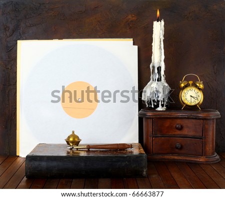 Antique record sleeve with book and candle