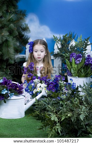 the lovely little girl plays in a garden