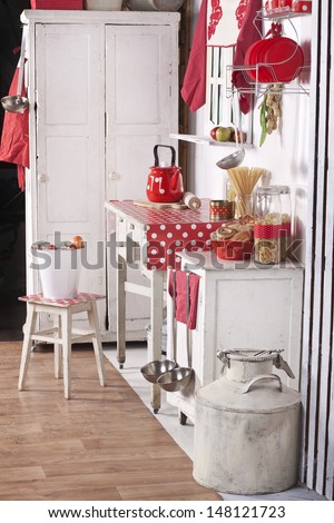 Red And White Kitchen With Old Furniture, Food And Utensils In A Country House