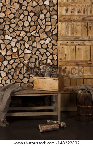 stack of wood, wooden wall made ??of planks, bench with storage compartment in the utility room