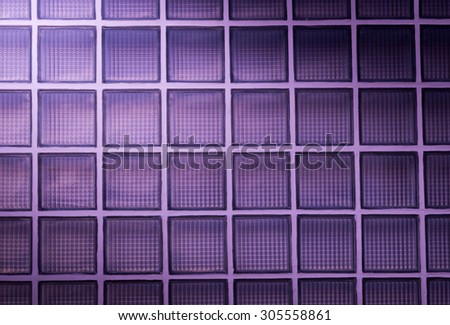 purple glass block wall background with lighting from corner