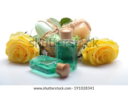 Mini set for spa, sauna bath - small bottles of shampoo, soap and flowers in still life