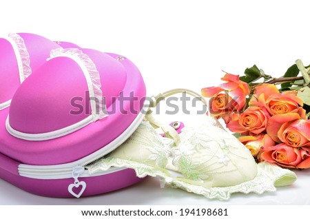 Female small suitcase for storing lingerie and rose flowers in still life