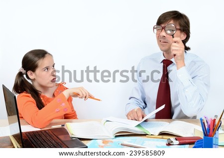Male teacher showing schoolgirl teen how to learn the world around us through a magnifying glass