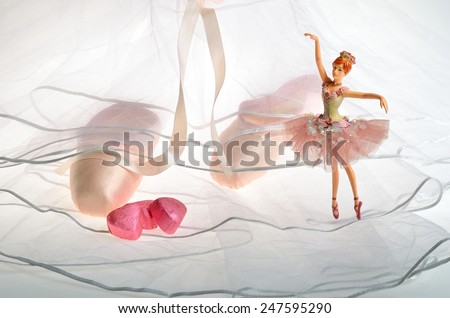 Pink ballet slippers, pointe shoes and dancing ballerina doll