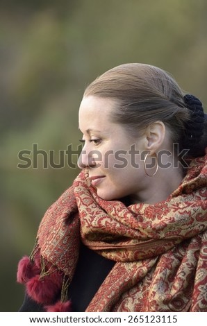 Portrait of a middle-aged woman in profile in a scarf, shawls