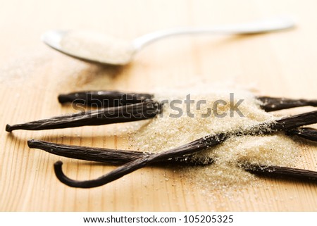 Light brown vanilla sugar and vanilla beans with small depth of field