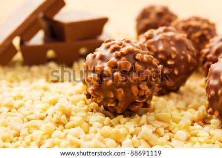 Chocolate candy balls with chopped nuts and chocolate bars