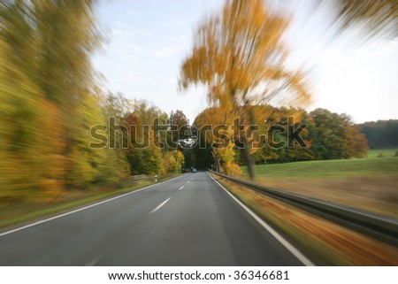 Traveling at full speed on a country road (clear focal point in the center)