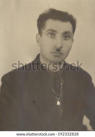 RUSSIA - CIRCA 1952s: An antique studio portrait of middle-aged man in a business suit.