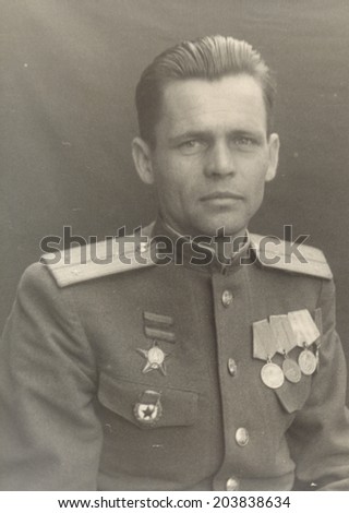 Ussr - CIRCA 1947: studio photo portrait of a  Captain of the Soviet Army, awarded the Order of Red Star, and three medals.