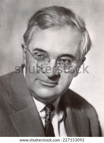 Russia, - CIRCA 1963s: An antique studio portrait of middle-aged man in a business suit, and glasses
