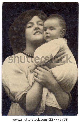USSR - CIRCA 1930s: Vintage photo shows portrait of a young mother and baby in her arms.