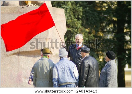 SMOLENSK, RUSSIA - MAY 1: Seniors speaking to each other. Senior man holds a red flag. May day (labor day) celebration on May 1, 2006 in Smolensk, Russia.