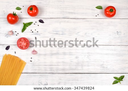 Italian pasta ingredients on white wooden table, top view, copy space