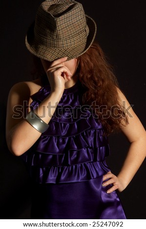 sexual woman dances in a hat having closed the face