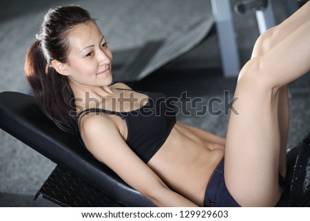 Woman at the gym doing exercises to strengthen the muscles of the legs