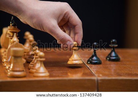 The figures placed on the board, a man\'s hand does pawn move