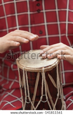 Men\'s hands beat the drum