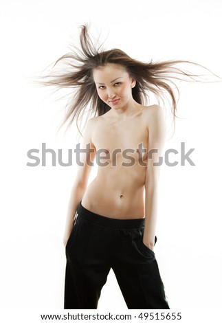 The Asian girl on a white background in sports trousers topless
