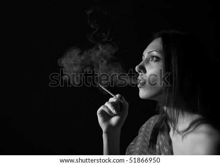 Portrait of the woman with a cigarette and a smoke against a dark background