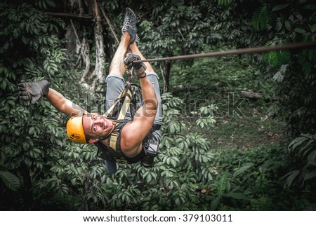 Man zipline flight in jungle