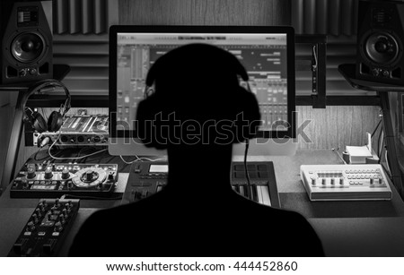 Men produce electronic music in project home studio. \
Silhouette. Black and white image.