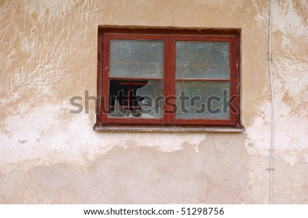 Small old wooden-frame window with dusty partly broken glass,from outside,on run-down wall with cracked paint.Layered PSD available from Envato: http://graphicriver.net/item/old-broken-window/100501