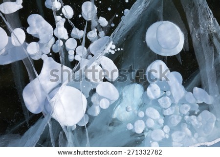 Ice of Baikal Lake. Natural background frozen water with gas bubbles