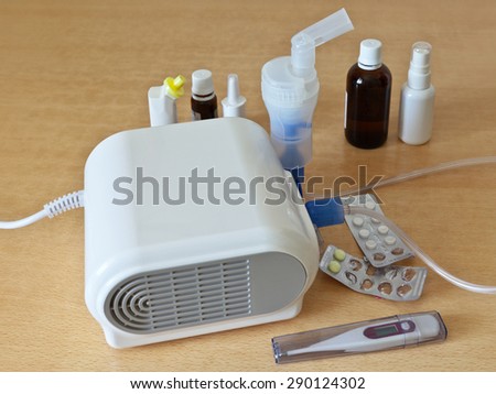 Treatment of allergy, asthma and pneumonia with a nebulizer. Tablets, drops, medicine and a thermometer