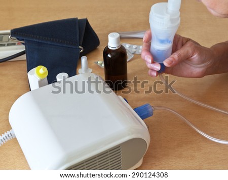 A sick person is treated at home and is breathing through a nebulizer