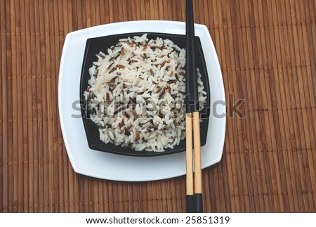 rice in cup and chinese sticks