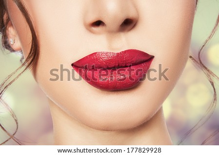 Big red lips closeup with locks of hair.