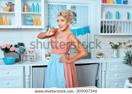 Girl in the kitchen wearing an apron. Old-fashioned style.