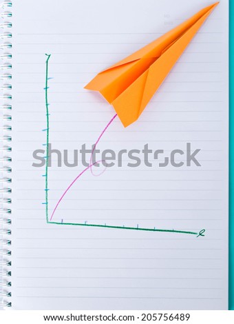 paper plane graph writing on notebook
