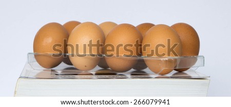 Row eggs on plastic tray