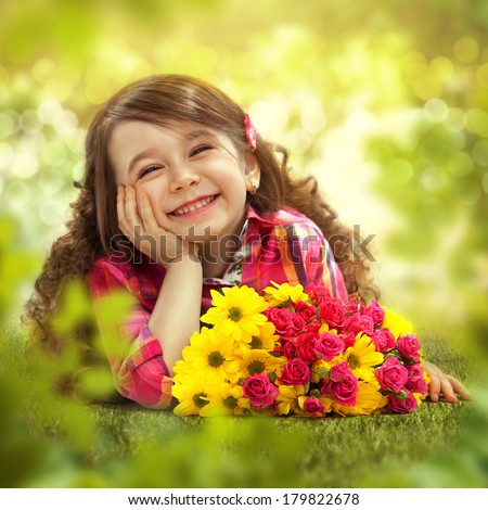 Smiling girl with big bouquet of flowers lying on grass. Spring, Mothers day, family holiday, Happiness concept.