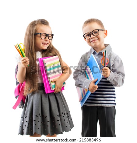 Two smiling school kids with colorful stationery, isolated on white background. School, education concept.