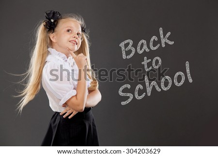 Pretty blonde schoolgirl. Place for text, education background. School, fashion concept