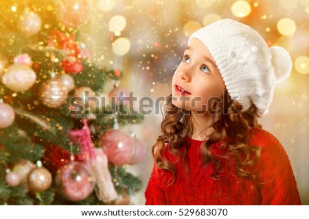 Merry Christmas and Happy New Year Holidays! Cute little girl near Christmas tree. Christmas card.