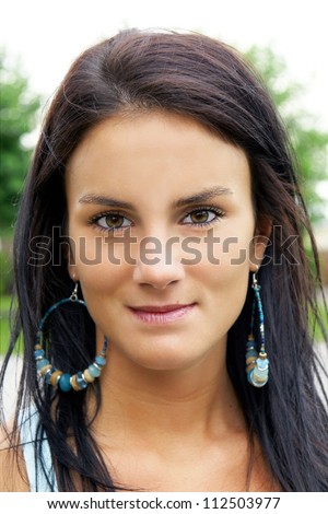 Portrait of a beautiful brunette young woman with girl next door look, could be of ethnic origin, native american or latino.