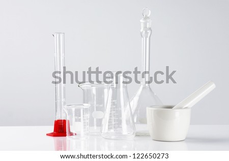 Science concept: empty laboratory glassware over light background,sterile look.