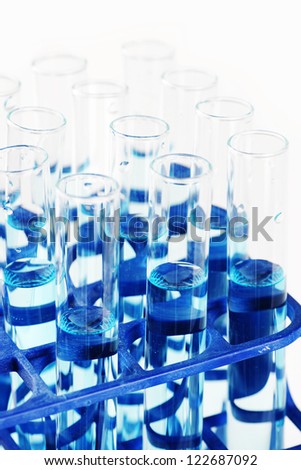 Macro of test tubes filled with blue liquid or chemical, great science, health or discovery background.